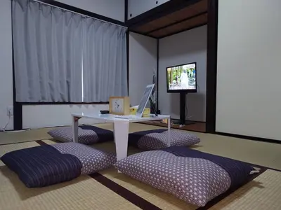 a room with a table and pillows and a television at Perfect for sightseeing in Tokyo! 6 people! \u56db\u3064\u6728 in Tokyo