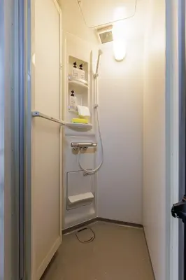 a small bathroom with a refrigerator in a room at Perfect for sightseeing in Tokyo! 6 people! \u56db\u3064\u6728 in Tokyo