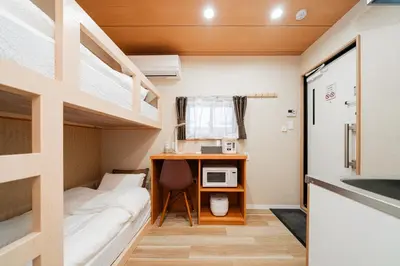 a small room with a desk and bunk beds at Oshiage SAIEI Executive Apartments in Tokyo