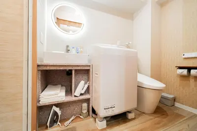 a bathroom with a mixer and a sink at Oshiage SAIEI Executive Apartments in Tokyo