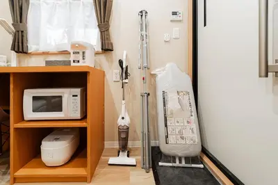 a room with a door and a microwave at Oshiage SAIEI Executive Apartments in Tokyo