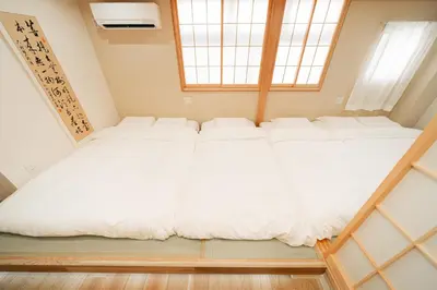 a large white bed in a room with a window at Oshiage SAIEI Executive Apartments in Tokyo