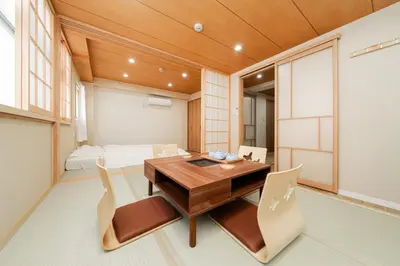 a dining room with a wooden table and chairs at Oshiage SAIEI Executive Apartments in Tokyo
