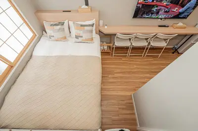 a small room with a bed and a table at Komorebi Asakusa Cozy 4P Stay The 77 House Tokyo in Tokyo