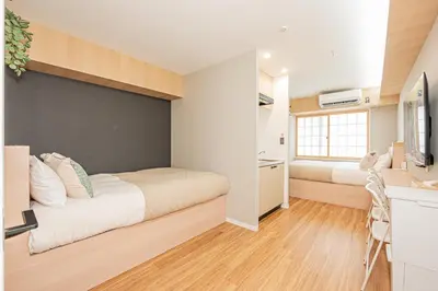 a small bedroom with a bed and a wall at Komorebi Asakusa Cozy 4P Stay The 77 House Tokyo in Tokyo