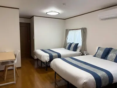 a hotel room with two beds and a table at \u79cb\u8449\u539f in Tokyo