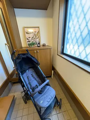a stroller sitting in a room with a window at \u79cb\u8449\u539f in Tokyo