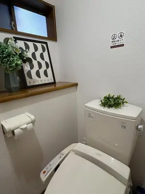 a bathroom with a toilet with a plant on top of it at \u79cb\u8449\u539f in Tokyo
