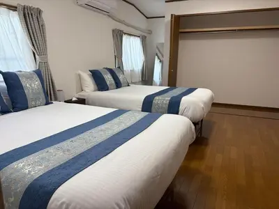 a hotel room with two beds and a couch at \u79cb\u8449\u539f in Tokyo