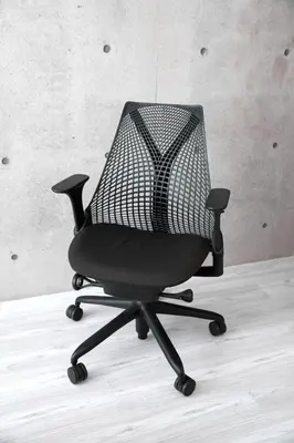 a mesh office chair sitting in a room at Shirogane Apartment in Tokyo