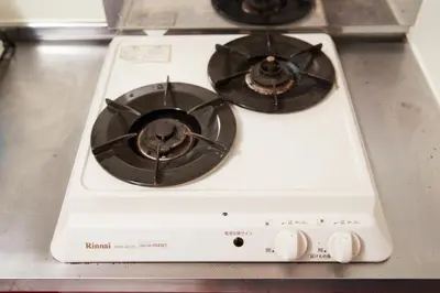 a white stove top with two burners on it at Shirogane Apartment in Tokyo