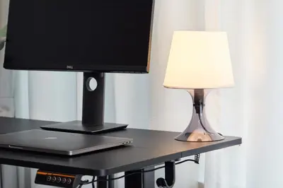 a desk with a computer monitor and a lamp on it at Shirogane Apartment in Tokyo