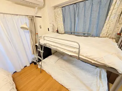a hospital bed in a room with a window at 302Near Ueno Heart of city in Tokyo