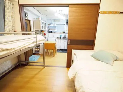 a room with two beds and a kitchen at 302Near Ueno Heart of city in Tokyo
