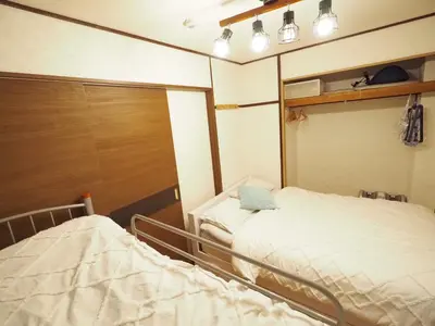 a hospital room with a bed and a laptop on it at 302Near Ueno Heart of city in Tokyo