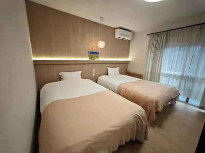 a hotel room with two beds and a window at ZYZ Sakuradai House NR0259 in Tokyo