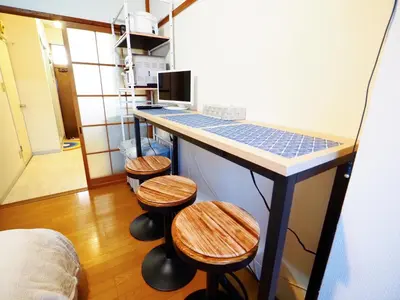 a room with a counter with stools and a counter top at 203 Koiwa Private House in Tokyo
