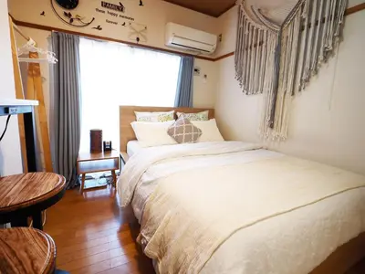 a bedroom with a bed and a table and a window at 203 Koiwa Private House in Tokyo
