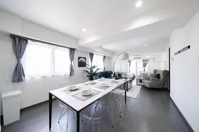 a dining room and living room with a table and chairs at K'shotel Takadanobaba 山手線駅6分繁華街に近い静かな住宅街のデザイナーズホテル in Tokyo