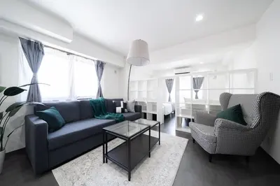 a living room with a couch and two chairs at K'shotel Takadanobaba 山手線駅6分繁華街に近い静かな住宅街のデザイナーズホテル in Tokyo