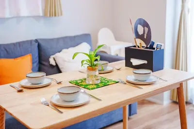 a wooden table with four dishes and a plant on it at SCD312 Eight subway lines connect to Tokyo business district, scarce 2 bathrooms, 2 toilets, warm space in Tokyo