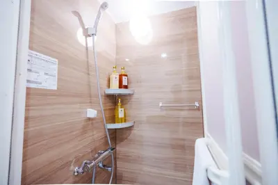a shower with a glass door with bottles on the wall at SCD312 Eight subway lines connect to Tokyo business district, scarce 2 bathrooms, 2 toilets, warm space in Tokyo
