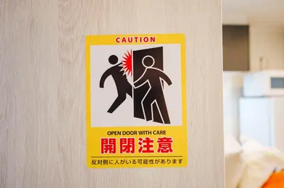 a caution sign on a door in a room at SCD312 Eight subway lines connect to Tokyo business district, scarce 2 bathrooms, 2 toilets, warm space in Tokyo