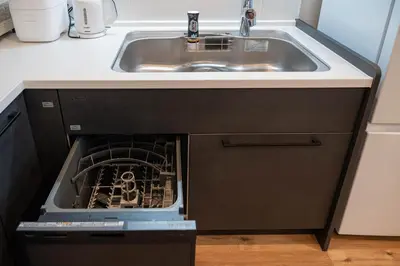 an open dishwasher in a kitchen next to a sink at SCD312 Eight subway lines connect to Tokyo business district, scarce 2 bathrooms, 2 toilets, warm space in Tokyo