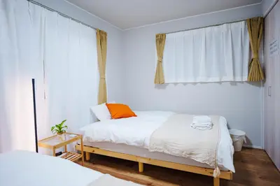 a white bedroom with a bed and a window at SCD312 Eight subway lines connect to Tokyo business district, scarce 2 bathrooms, 2 toilets, warm space in Tokyo