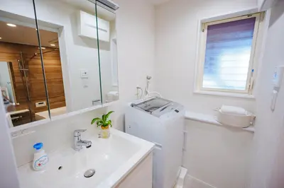 a white bathroom with a sink and a refrigerator at SCD312 Eight subway lines connect to Tokyo business district, scarce 2 bathrooms, 2 toilets, warm space in Tokyo