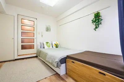 a bedroom with a bed and a large window at \u5e73\u548c\u5cf6801 in Tokyo