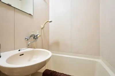 a white bathroom with a sink and a tub at \u5e73\u548c\u5cf6801 in Tokyo