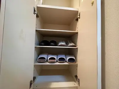 a cupboard with a door open with someones shoes at \u5e73\u548c\u5cf6801 in Tokyo