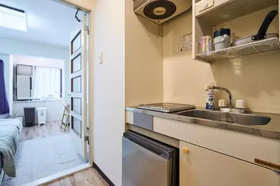 a small kitchen with a sink and a counter top at \u5e73\u548c\u5cf6801 in Tokyo