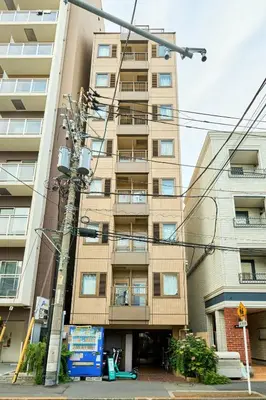 an apartment building with a utility pole in front of it at \u5e73\u548c\u5cf6801 in Tokyo