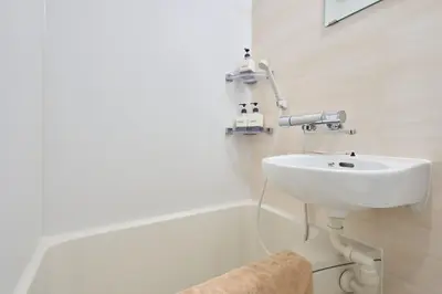 a bathroom with a white sink and a mirror at \u5e73\u548c\u5cf6202 in Tokyo
