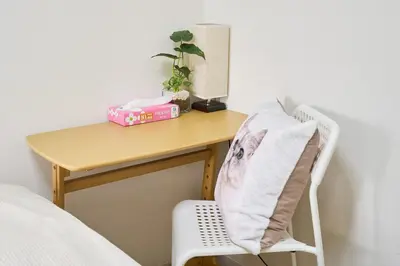 a desk with a chair next to a table with a bed at \u5e73\u548c\u5cf6202 in Tokyo