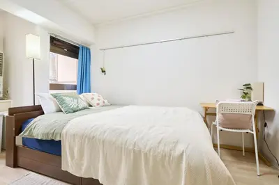 a white bedroom with a bed and a desk at \u5e73\u548c\u5cf6202 in Tokyo