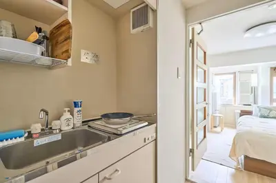 a kitchen with a sink and a bed in a room at \u5e73\u548c\u5cf6202 in Tokyo