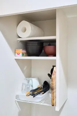 a kitchen cabinet with some bowls and utensils at \u5e73\u548c\u5cf6202 in Tokyo