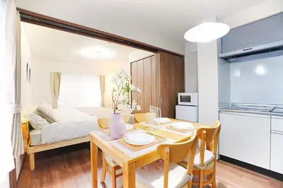 a kitchen and dining room with a table and a bed at Nakano Cozy House\u4e2d\u91ce\u30b3\u30fc\u30b8\u30fc\u30cf\u30a6\u30b9 in Tokyo