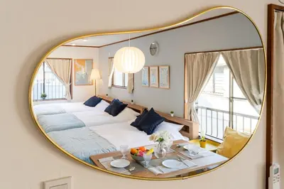 a bedroom with a large mirror on the wall at tai\u4e0a\u5317\u6ca24\u4e01\u76ee in Tokyo