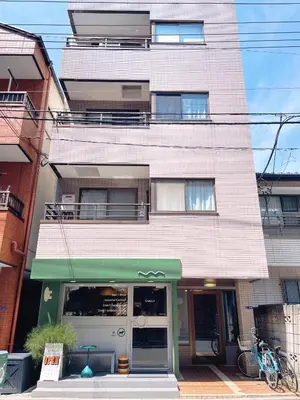 a building with a green awning in front of it at Sakura Stay \u62bc\u4e0a in Tokyo