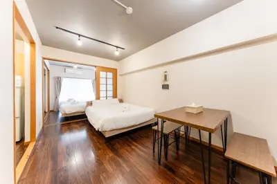 a bedroom with a bed and a table in it at shibuya e adress in Tokyo