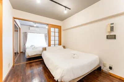 a bedroom with two beds and a window at shibuya e adress in Tokyo
