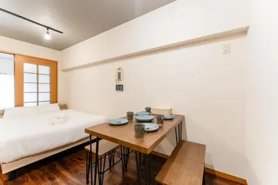 a bedroom with a bed and a wooden table at shibuya e adress in Tokyo