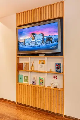 a flat screen tv sitting on top of a book shelf at Tokyo Skytree House 4LDK, 2Bath, 9 Guests, 6min to Keisei Hikifune in Tokyo