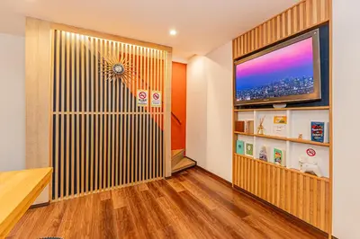 a living room with a large screen tv on a wall at Tokyo Skytree House 4LDK, 2Bath, 9 Guests, 6min to Keisei Hikifune in Tokyo