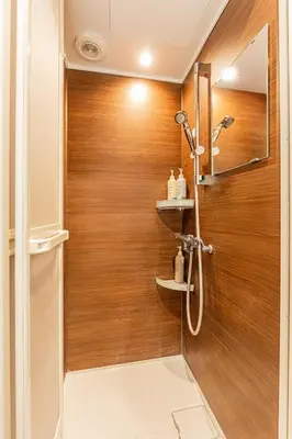 a shower in a bathroom with a wooden wall at Tokyo Skytree House 4LDK, 2Bath, 9 Guests, 6min to Keisei Hikifune in Tokyo