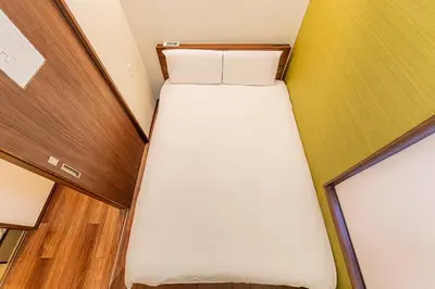 a small bedroom with a bed in a room at Tokyo Skytree House 4LDK, 2Bath, 9 Guests, 6min to Keisei Hikifune in Tokyo